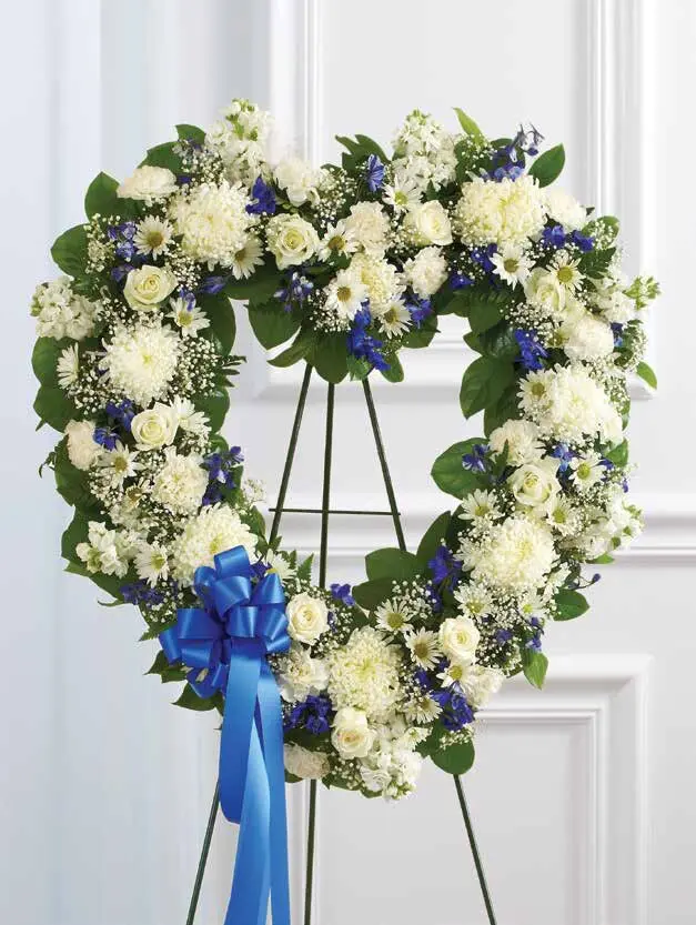 Open blue and white heart of roses and mums on an easel with blue bow