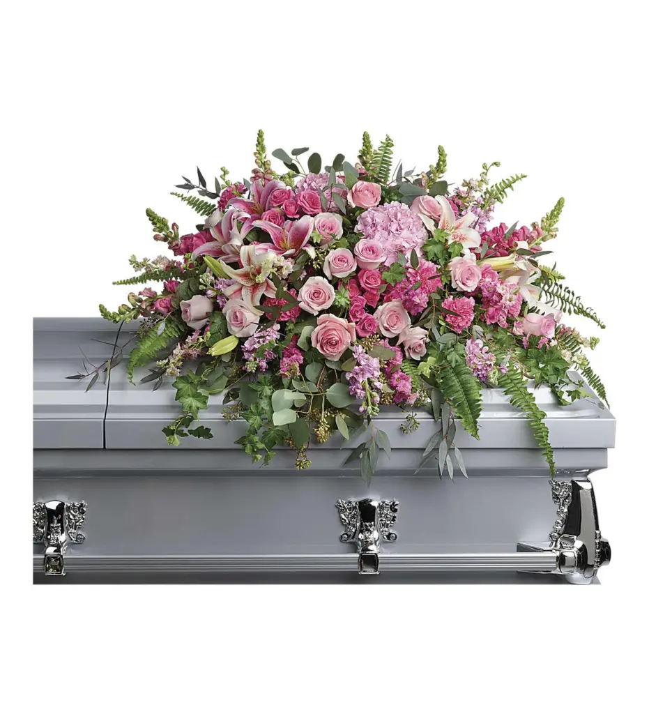 Pink roses, lilies and hydrangea casket spray on a silver-gray casket