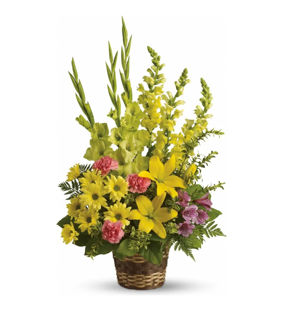 Woven basket of yellow lilies, green gladiolus, yellow snapdragons and pink carnations