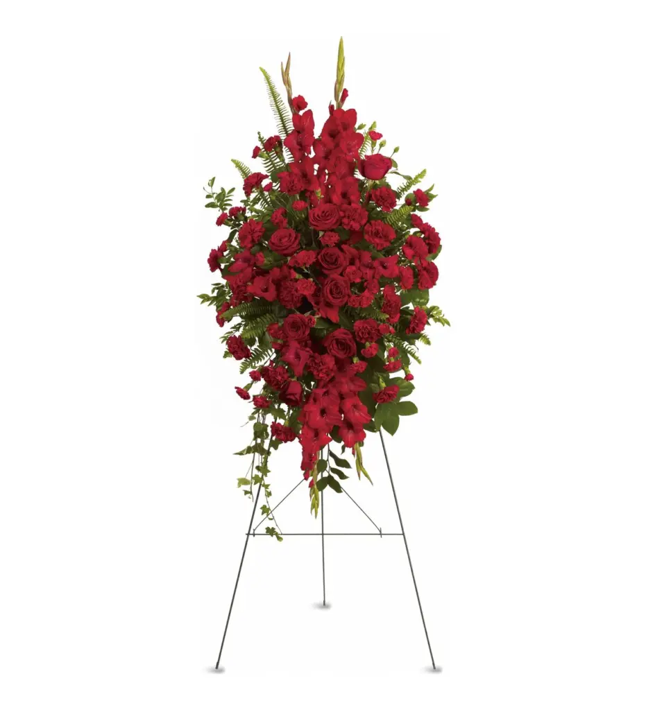 All-red standing spray of gladiolus, roses and carnations on a wire easel