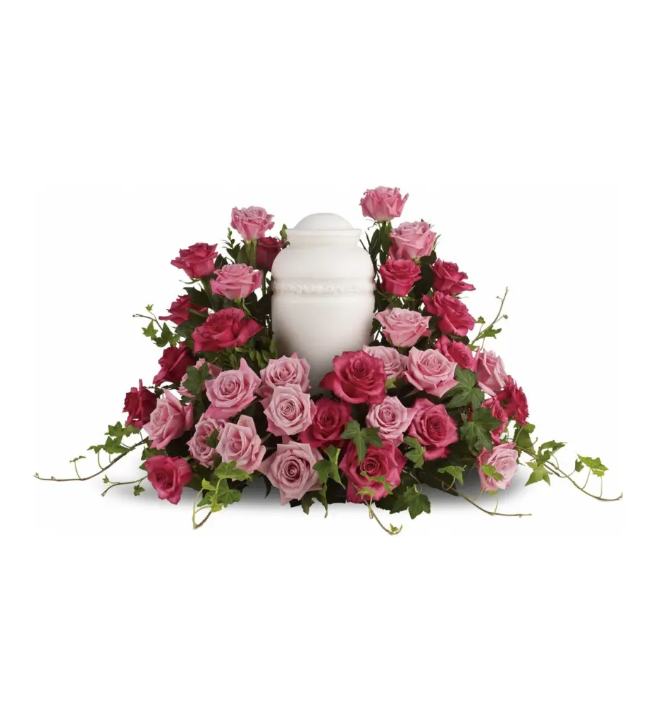 Ring of light and hot pink roses with ivy surrounding a white urn