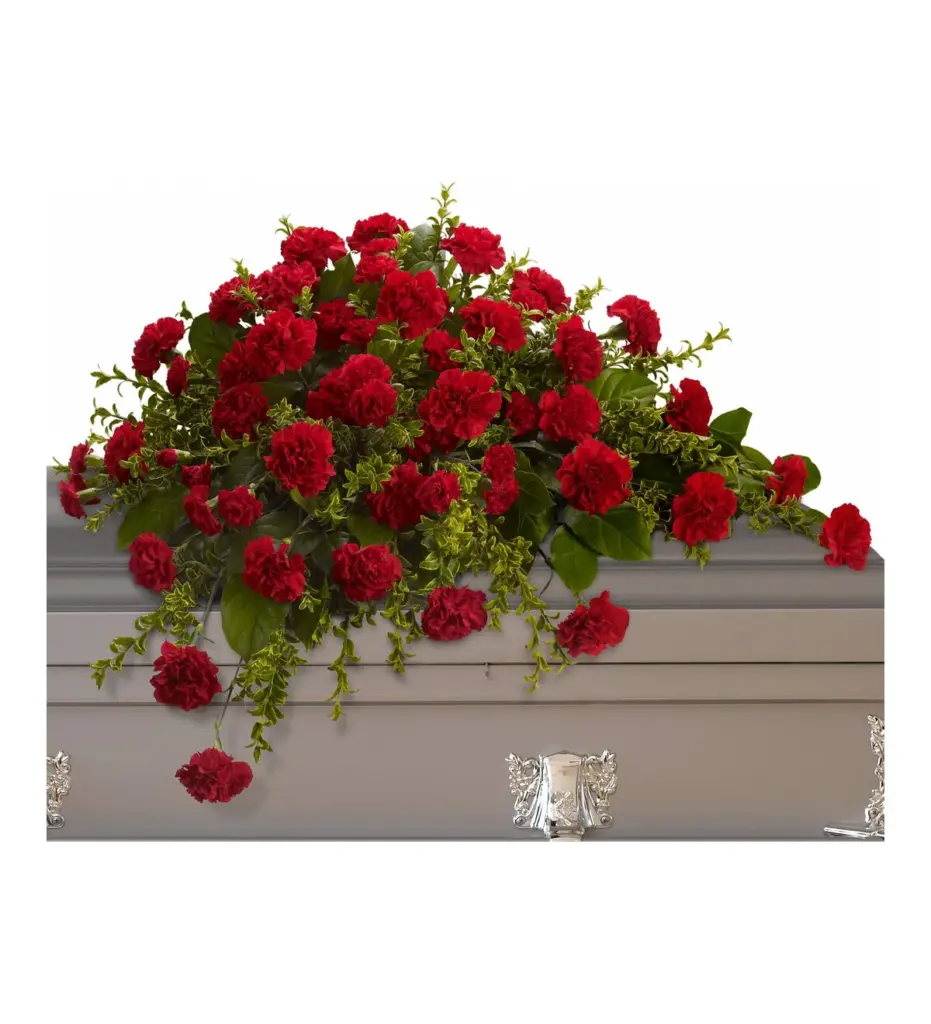 Red carnation half casket spray with greenery on a gray casket