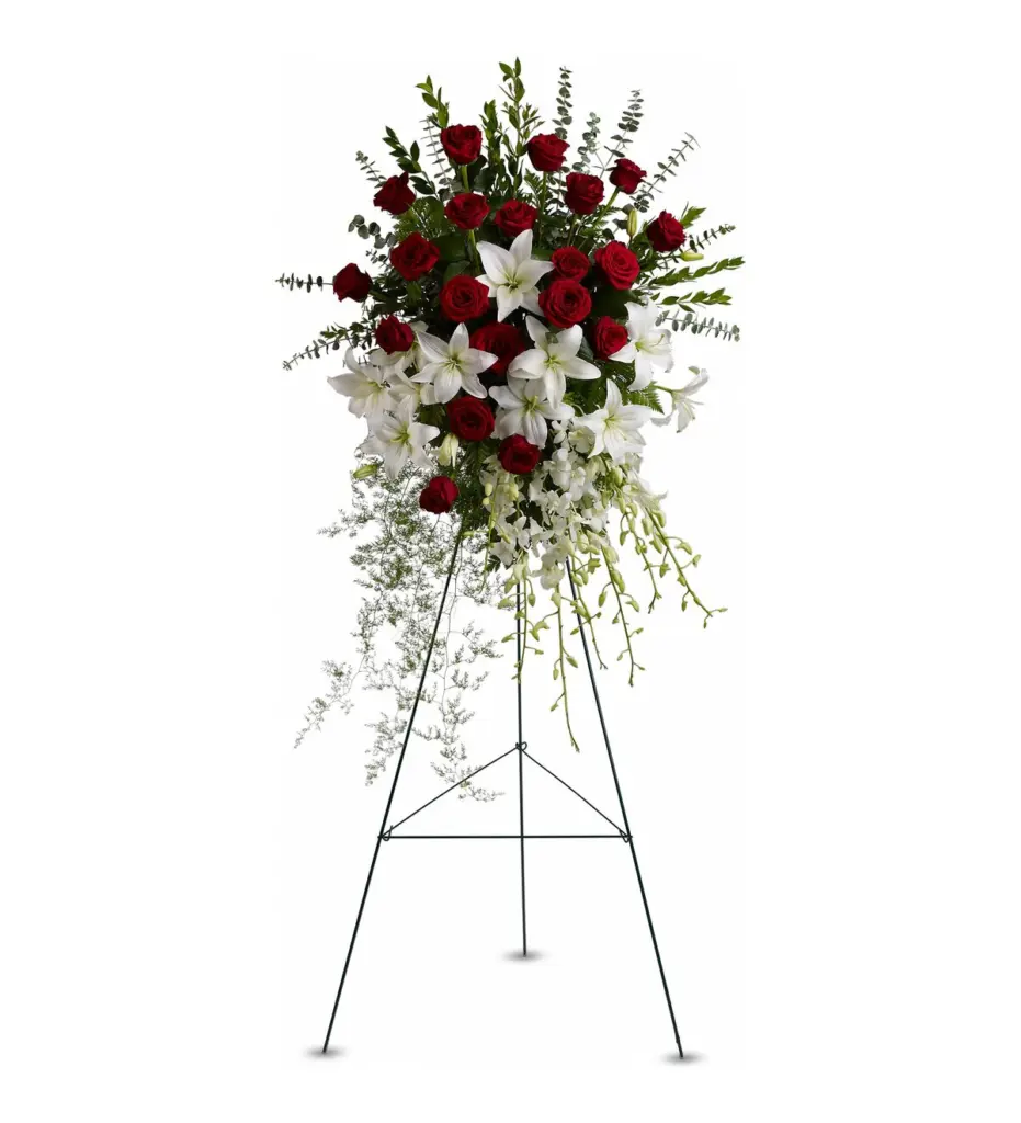 Red rose and white lily standing spray with cascading orchids on a wire easel