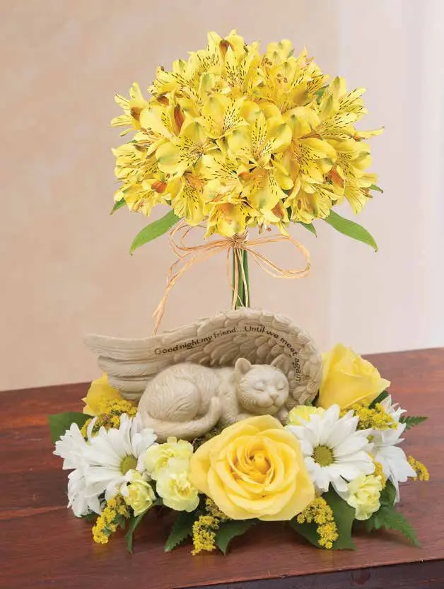 Sleeping cat angel figurine with yellow roses, daisies and alstroemeria topiary