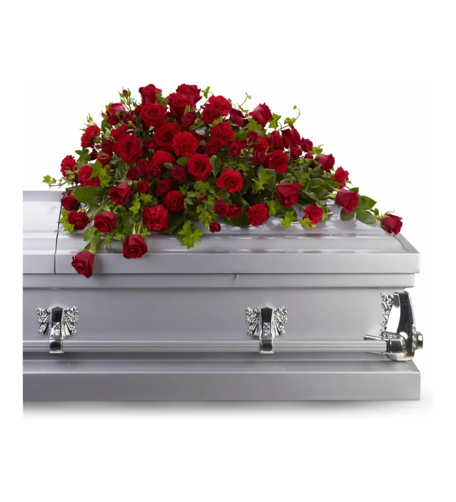 Red rose and carnation half casket spray with ivy on a silver casket