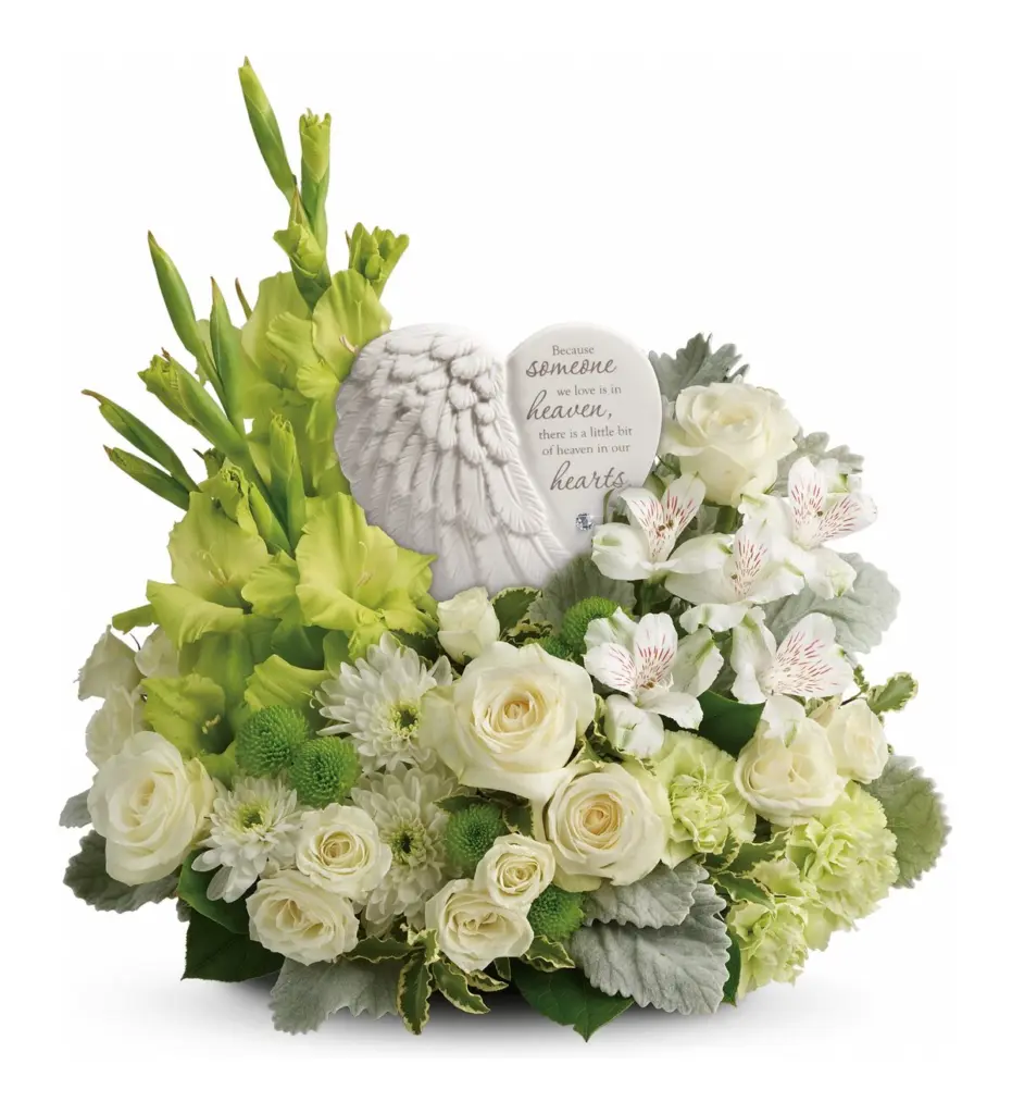 White roses and green gladiolus around a white angel-wing heart plaque with verse