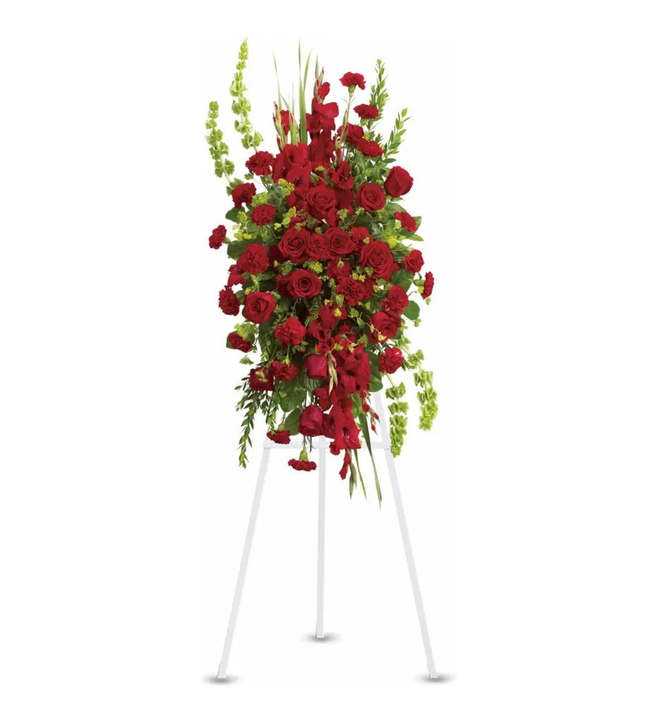Red rose, carnation and gladiolus standing spray on a white easel