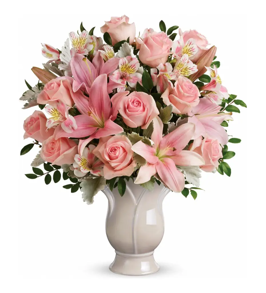 Light pink roses and lilies in a cream ceramic vase