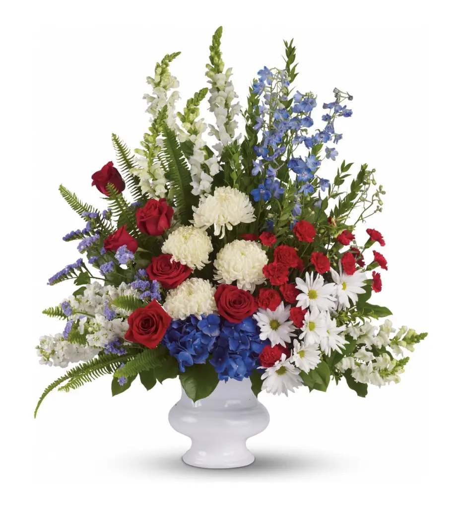 Red, white and blue arrangement of roses and hydrangea in a white urn