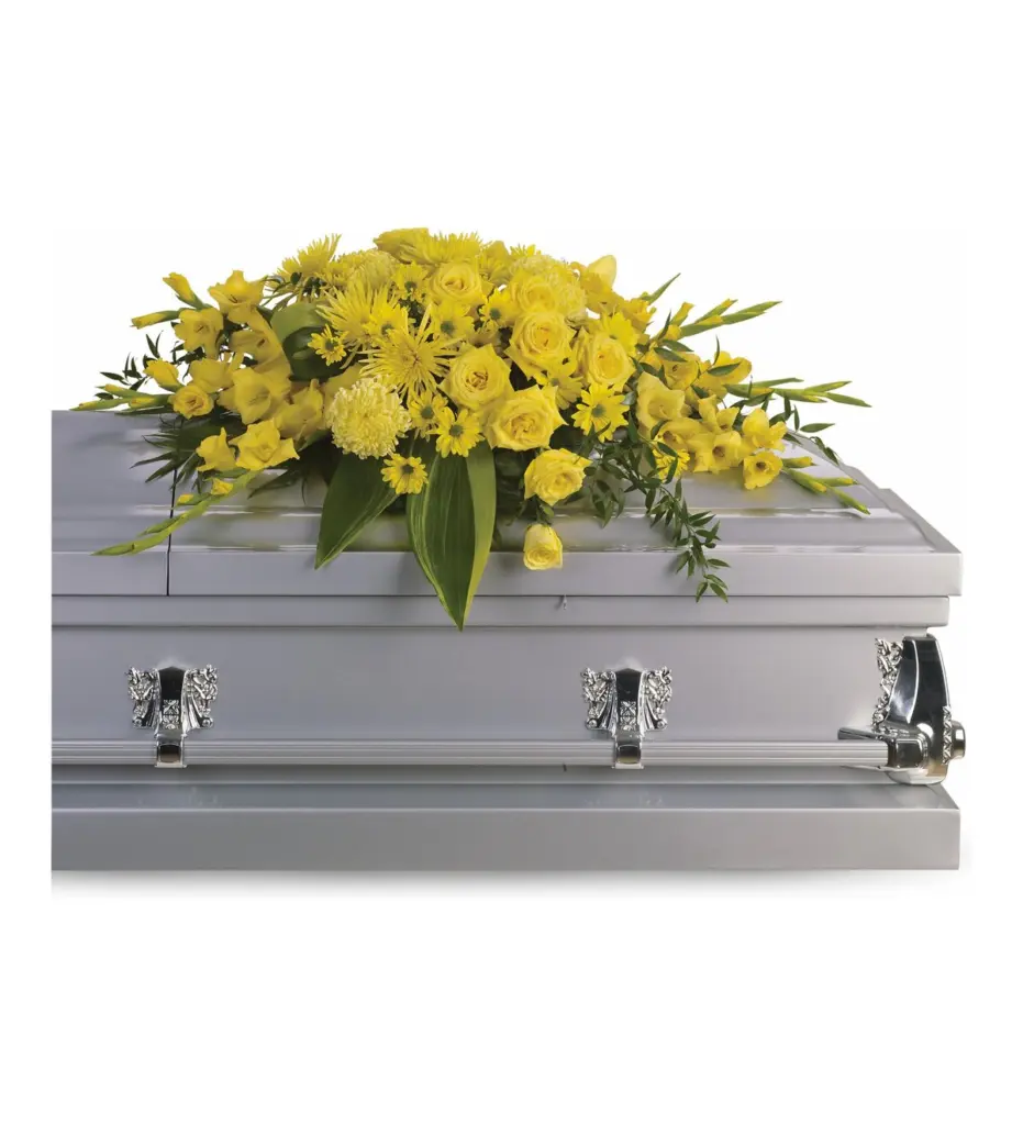 Yellow rose and gladiolus half casket spray on a silver casket