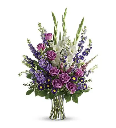 Purple and white flowers in a clear glass vase with roses and gladiolus (alternate view)