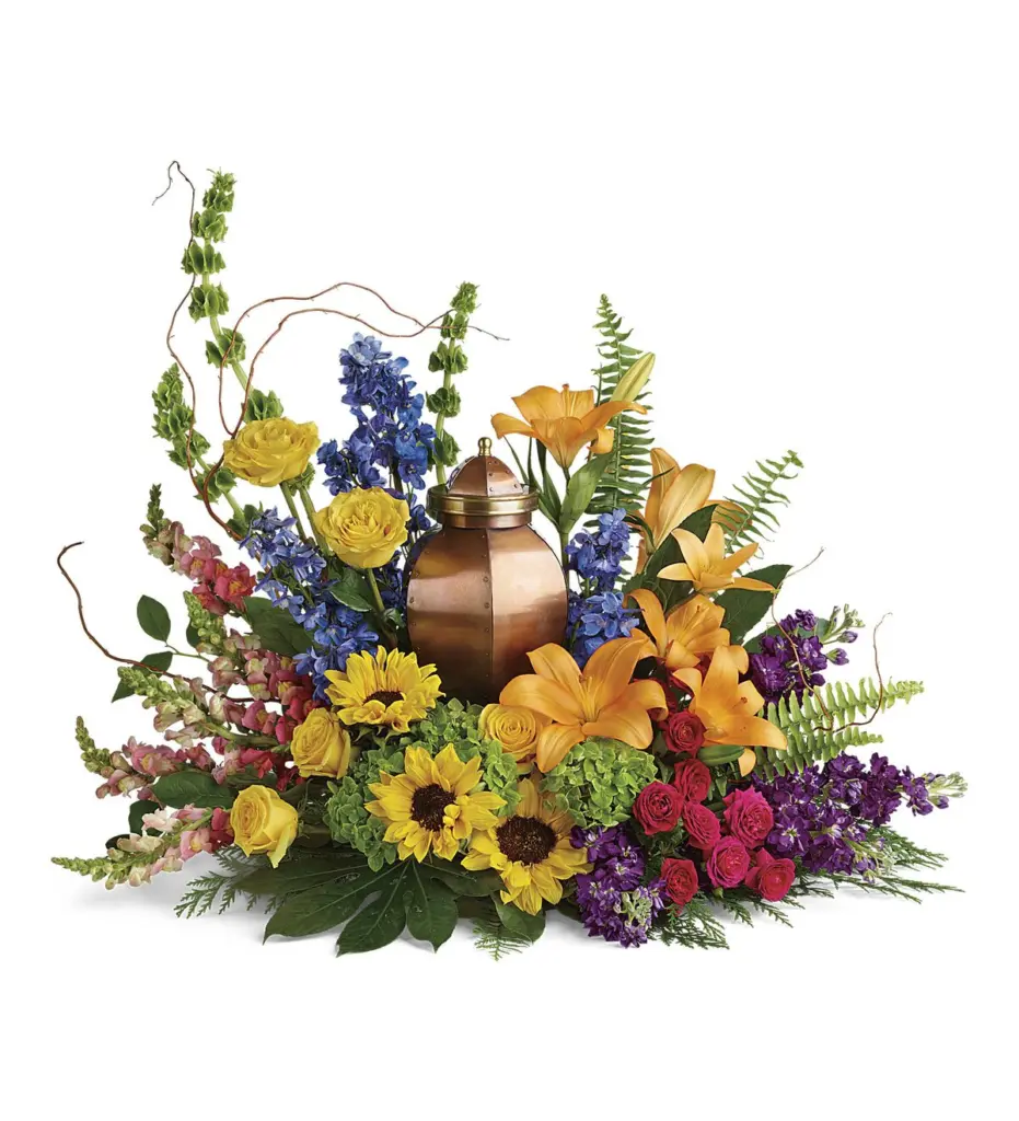 Sunflowers, orange lilies and blue delphinium surrounding a copper memorial urn