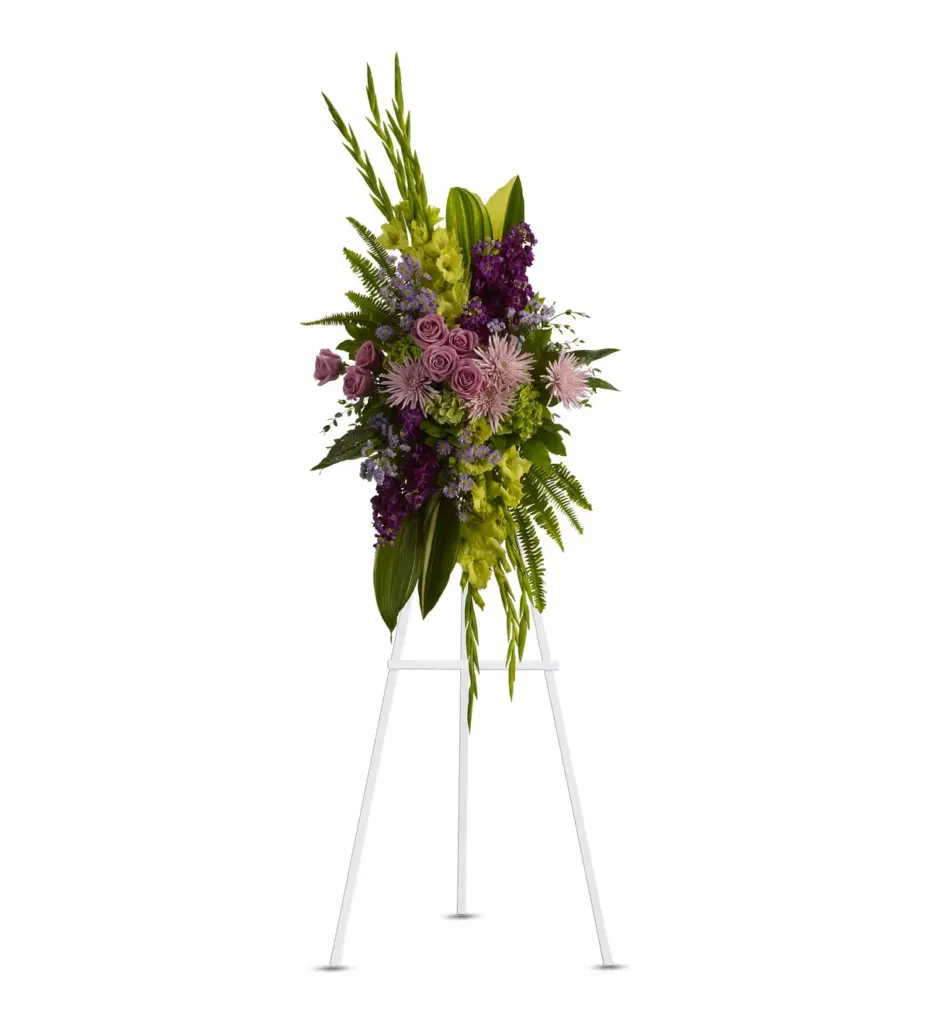 Purple and green standing spray with lavender roses, spider mums and gladiolus on easel