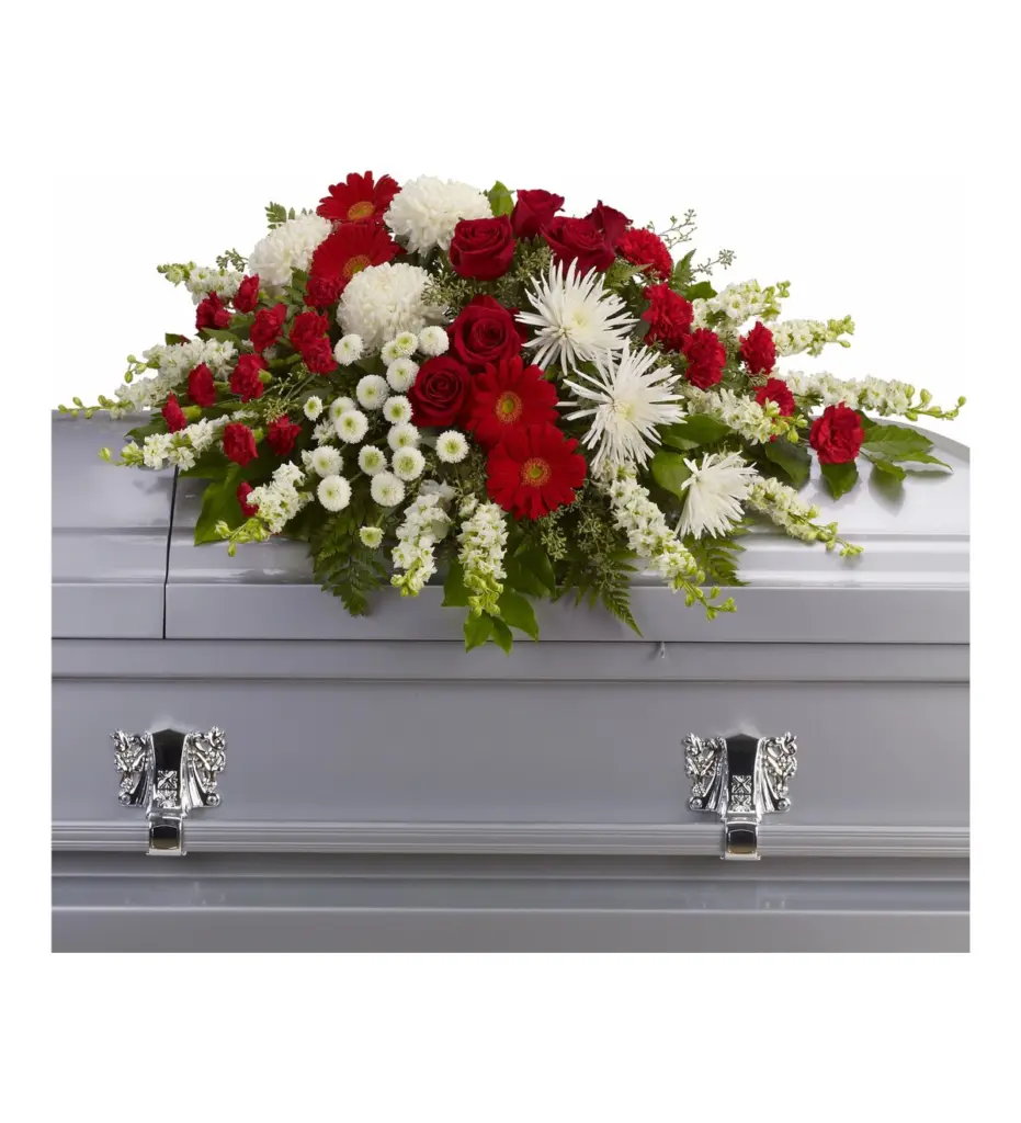 Red and white casket spray of roses, gerberas, carnations and white mums on a silver casket