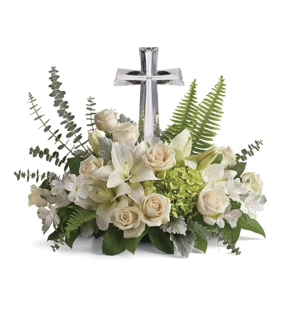Cream roses and white lilies around a clear crystal-look cross