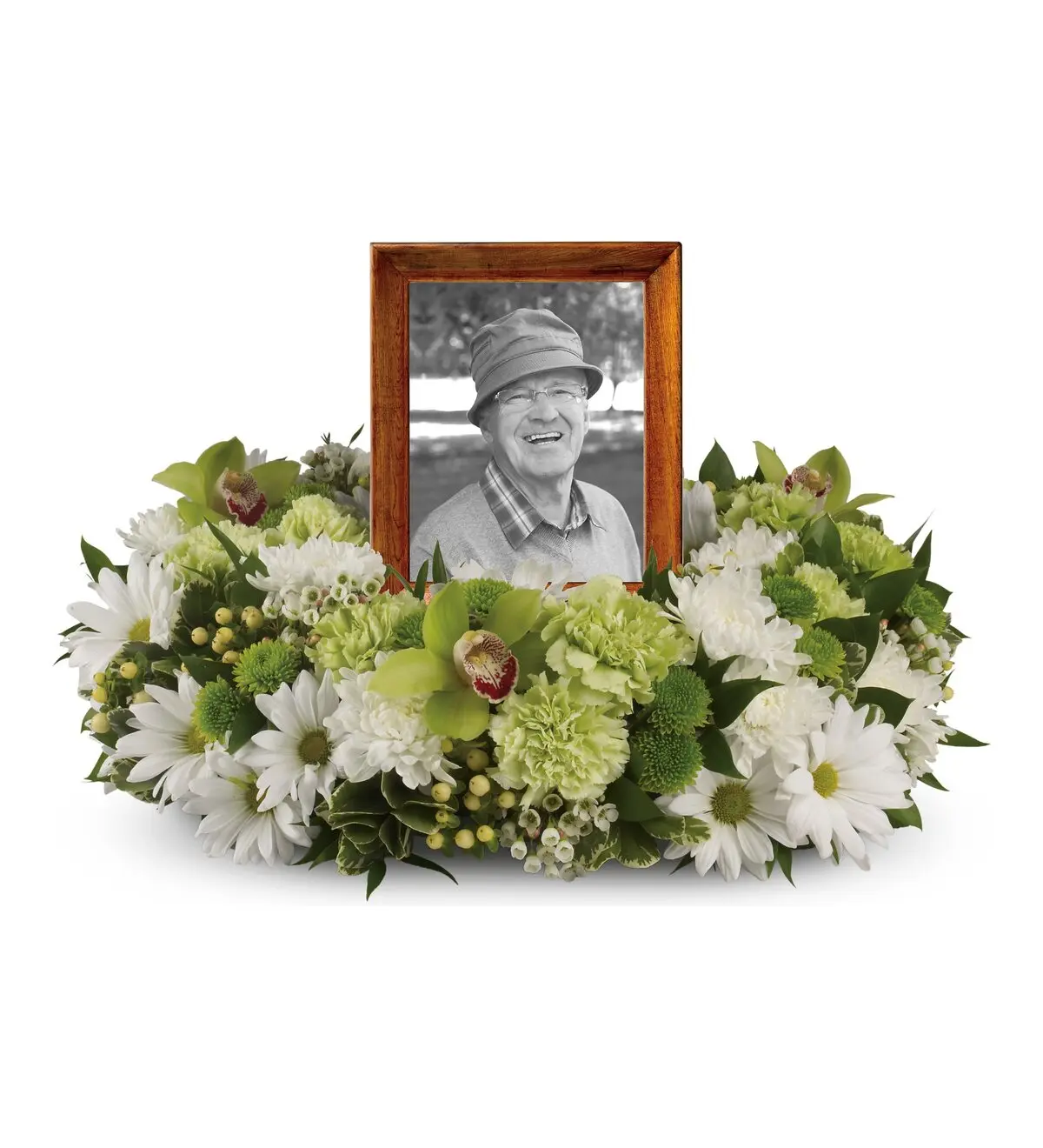Low ring of white daisies and green flowers around a wood-framed portrait photo