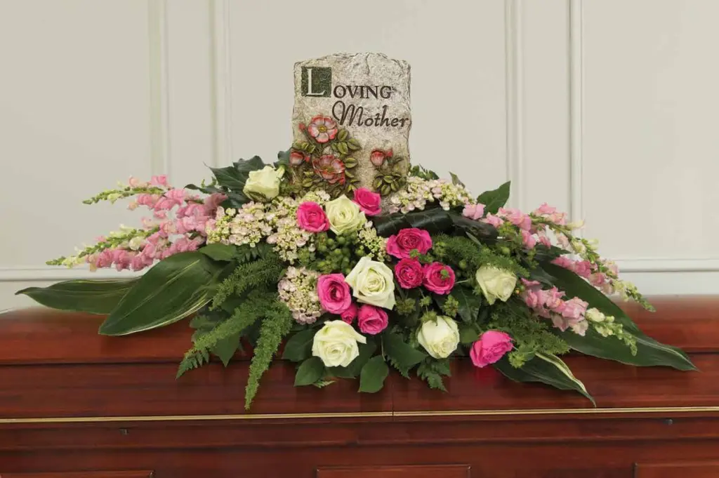 Pink and white rose casket spray with a Loving Mother stone plaque