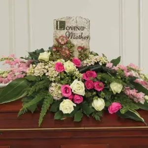Pink and white rose casket spray with a Loving Mother stone plaque