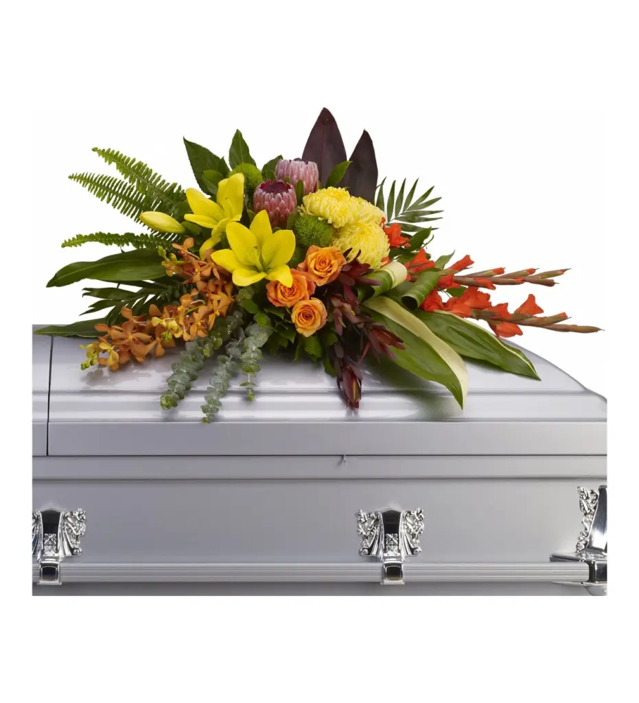 Tropical half casket spray with protea, yellow lilies, orange roses and orchids on silver casket