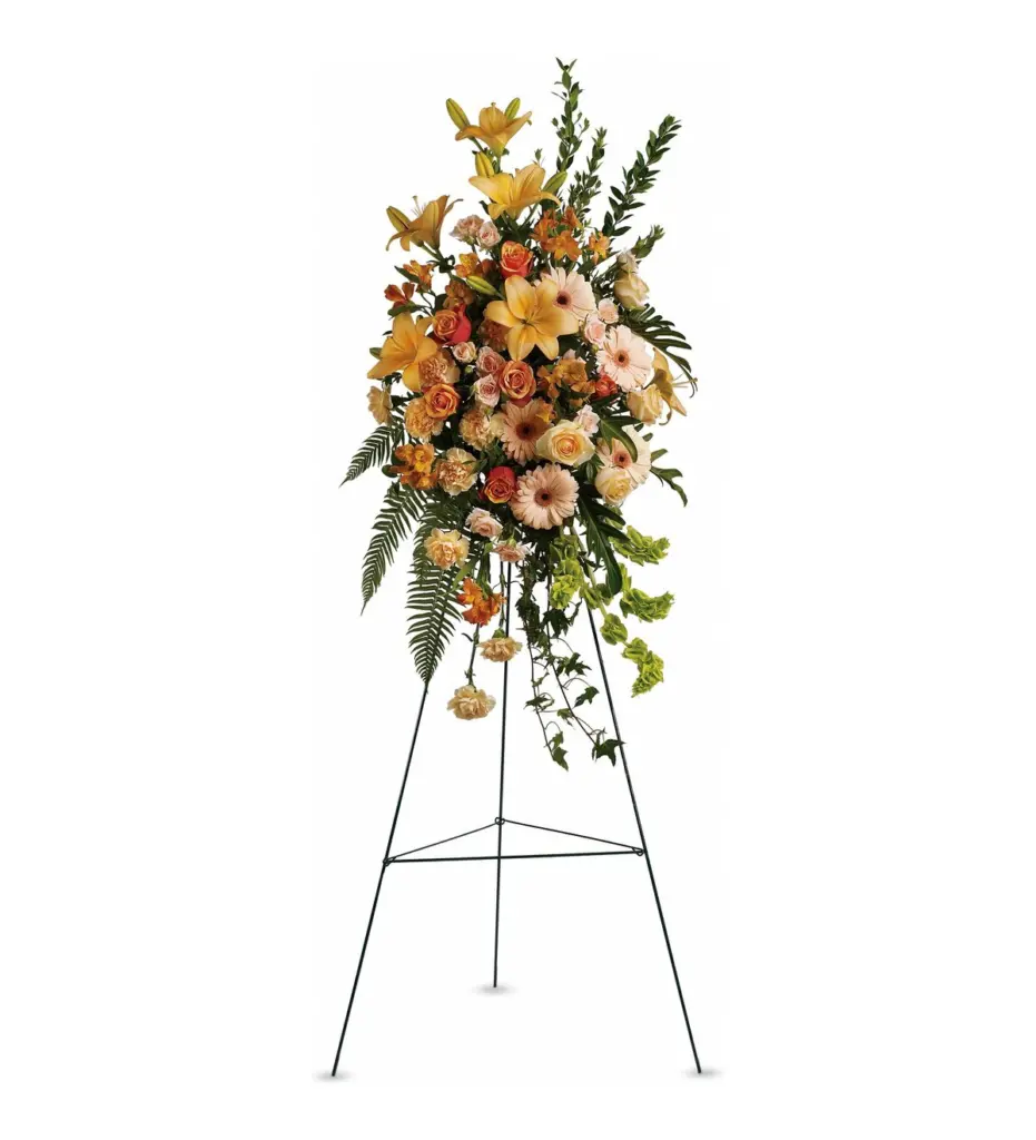 Peach and orange standing spray of lilies, roses and gerberas on wire easel