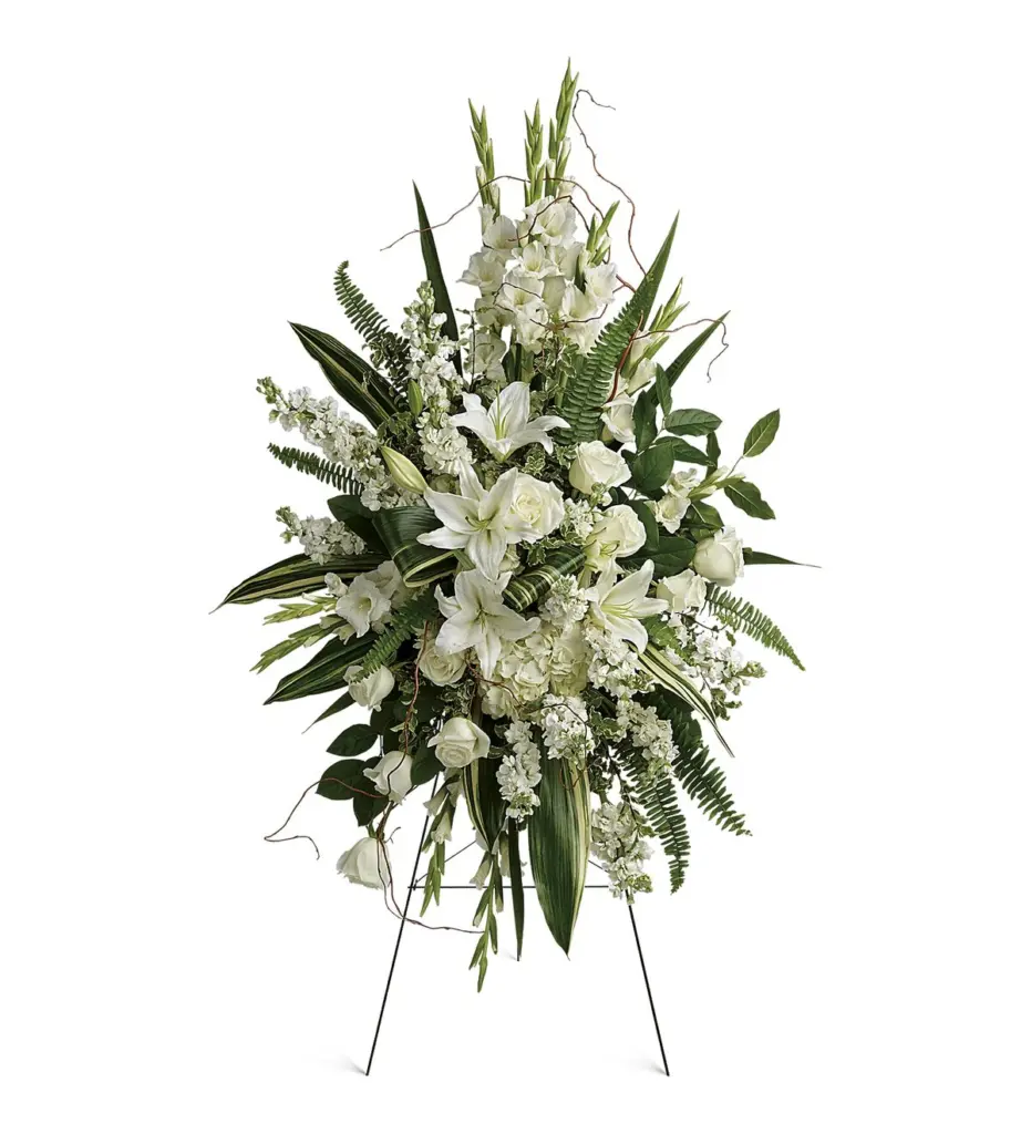 White gladiolus, lilies and roses standing spray on a wire easel
