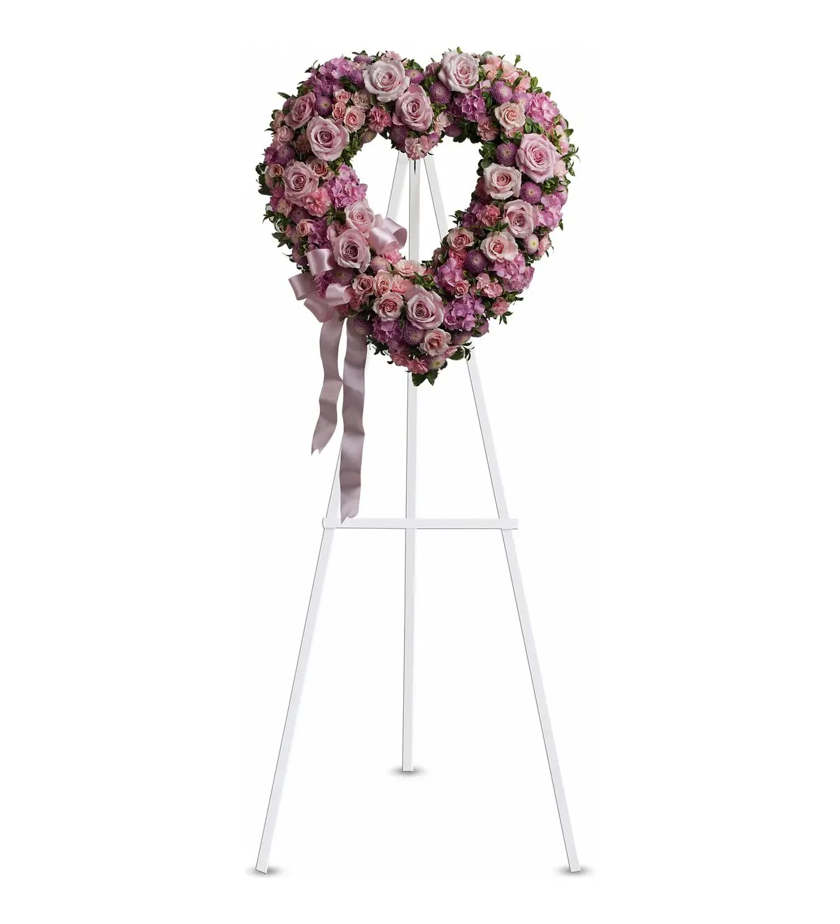 Pink open heart of roses and hydrangea with a satin bow on a white easel