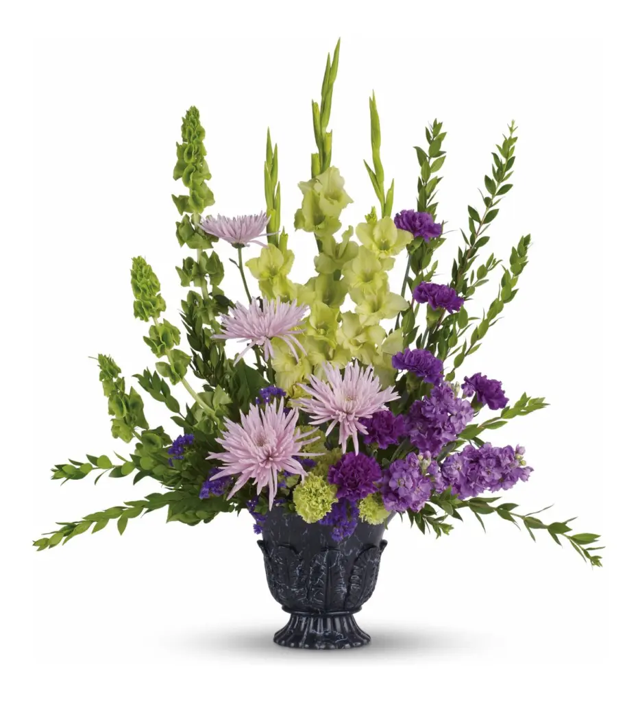 Lavender spider mums and green gladiolus in a dark marbled pedestal container