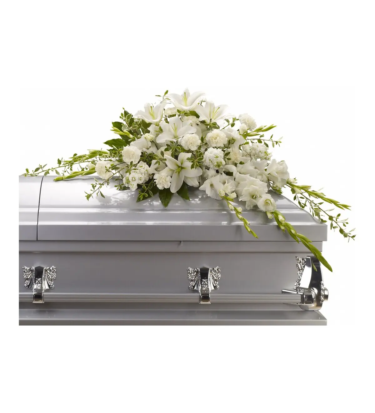 White half casket spray of lilies, carnations, stock and gladiolus on a silver casket