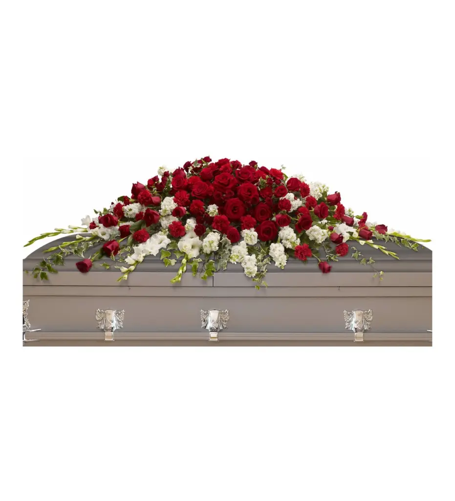 Long red rose and carnation casket spray with ivy on a gray casket