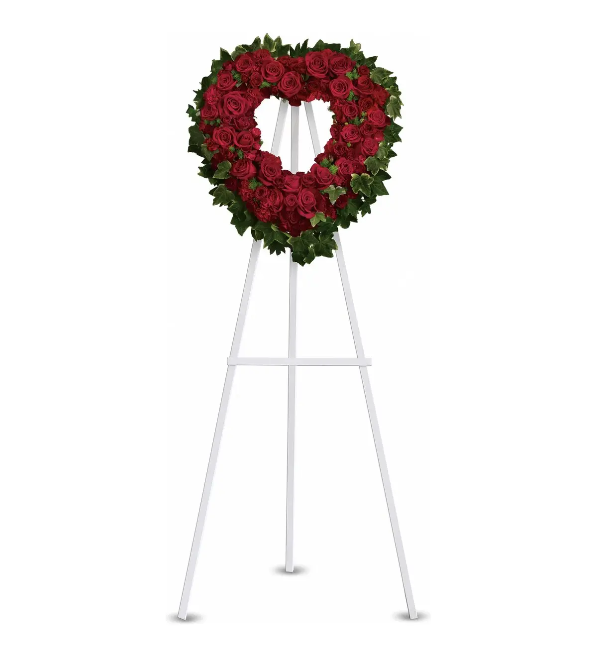 Open heart of red roses and carnations framed by ivy on a white easel