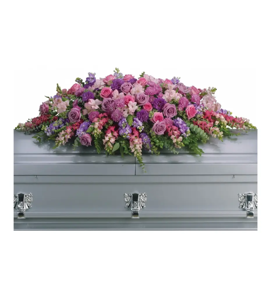Full pink and lavender casket spray of roses and snapdragons on a casket