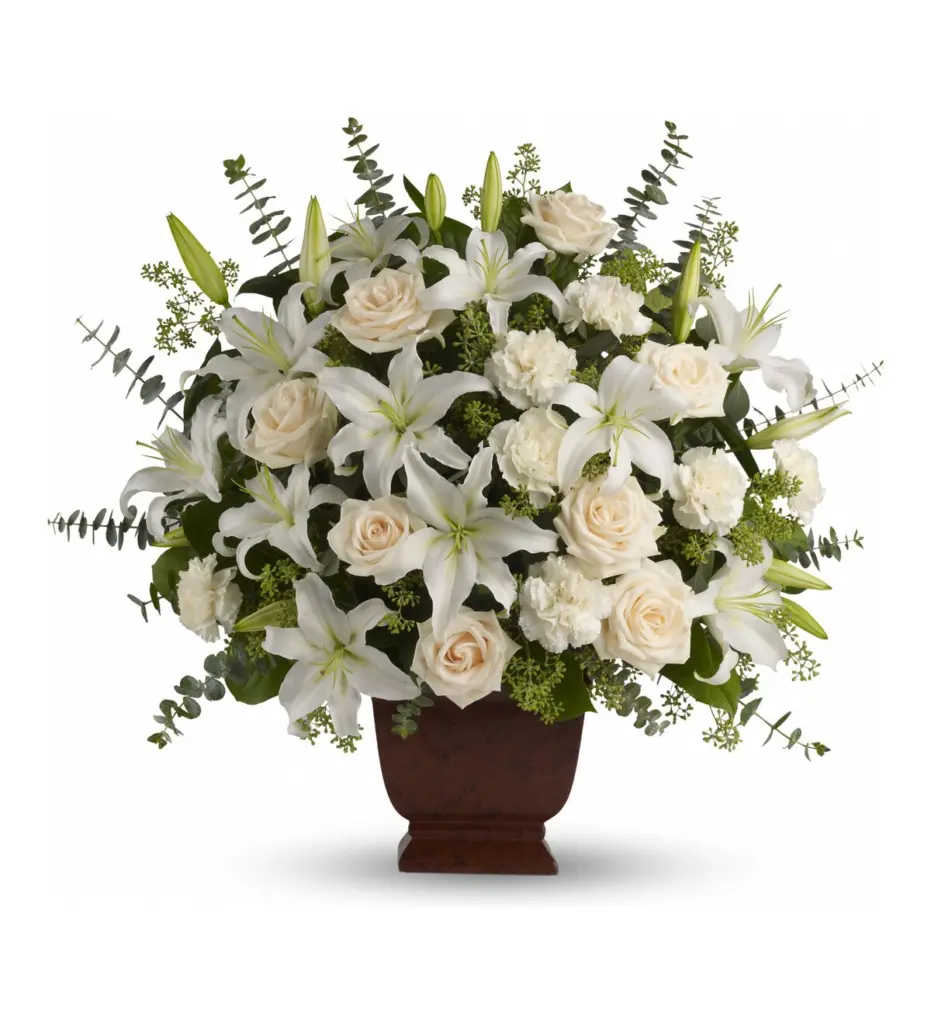 Large white lily, cream rose and carnation arrangement in a brown footed container