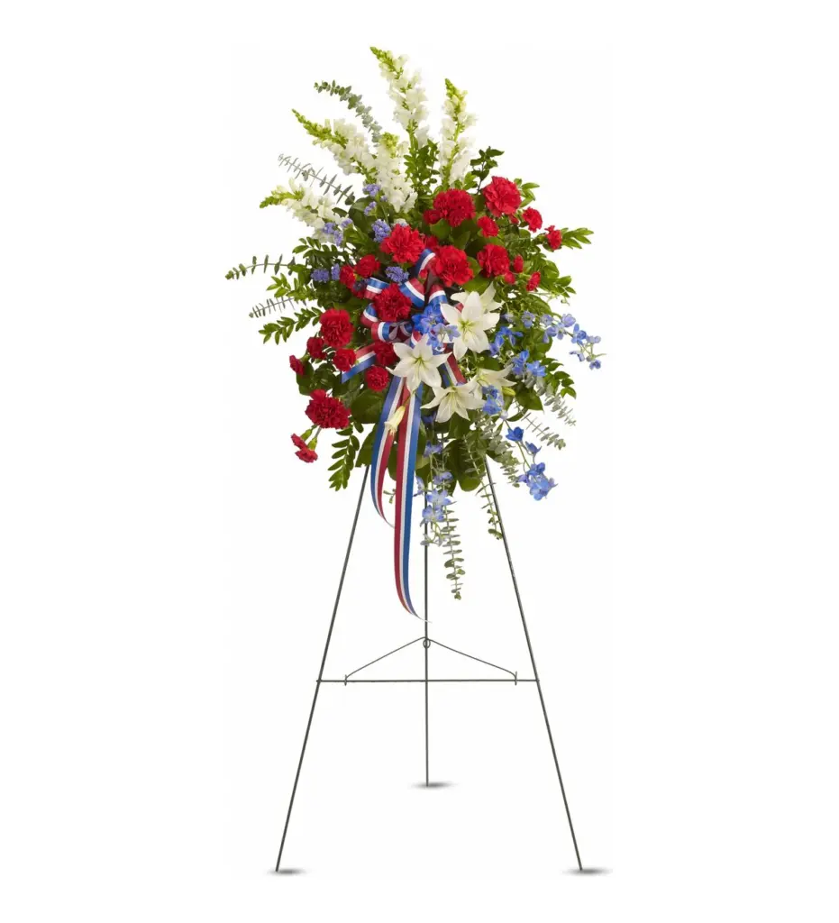 Red, white and blue standing spray with striped ribbon on a wire easel