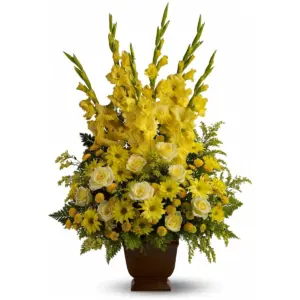 Tall yellow gladiolus, roses and daisy mums in a brown footed container