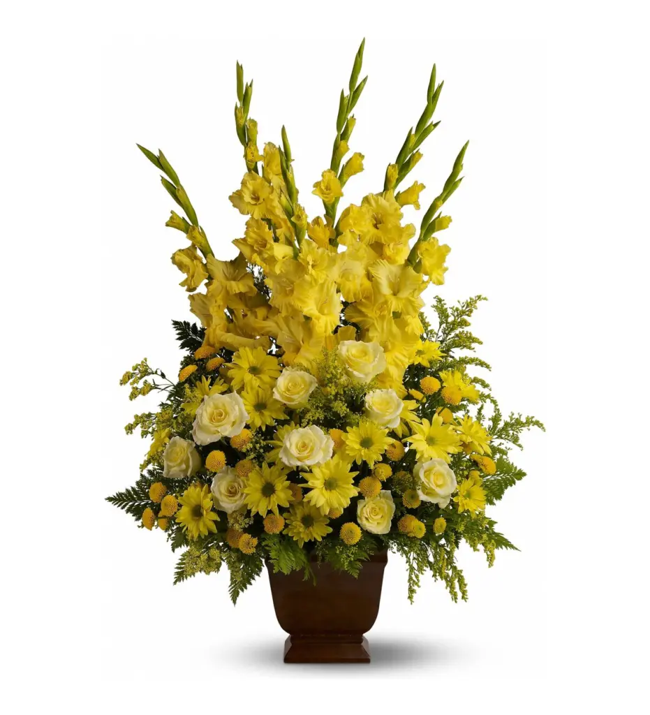Tall yellow gladiolus, roses and daisy mums in a brown footed container