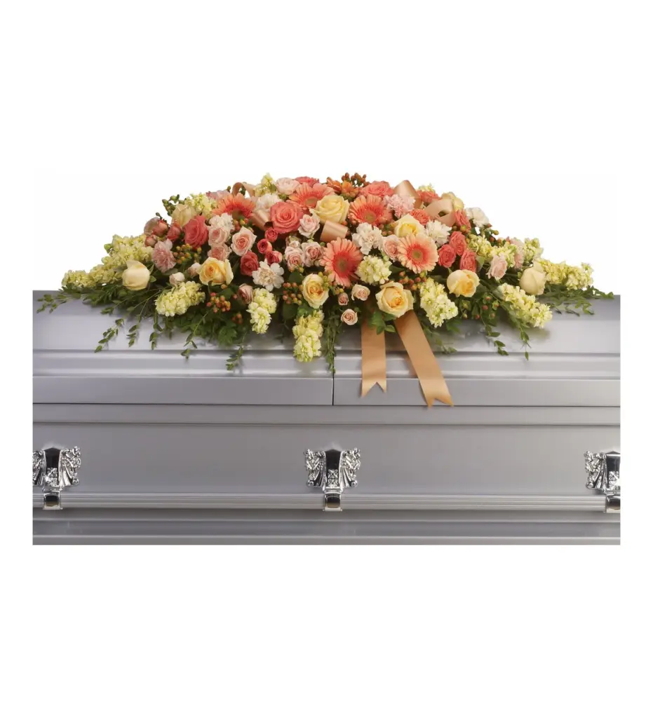 Peach and coral casket spray with roses, gerberas and ribbon on silver casket
