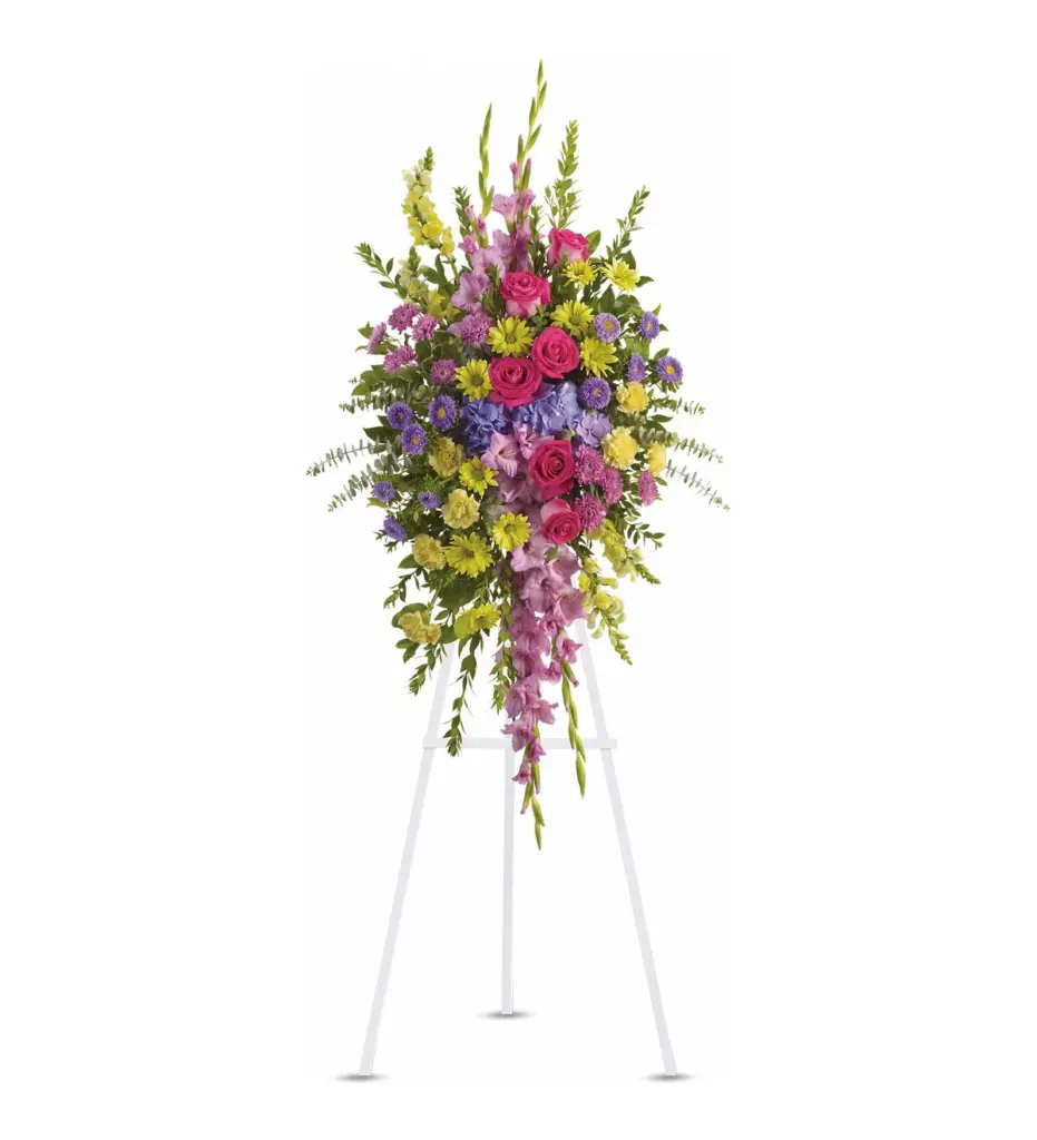 Colorful standing spray of pink roses, lavender gladiolus, hydrangea and yellow daisies on easel