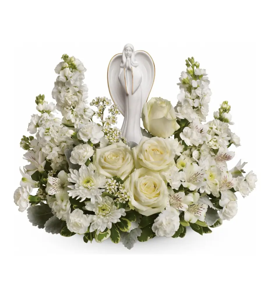 White roses and stock surrounding a white porcelain praying angel figurine