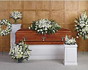 Funeral room with white casket spray, wreath, standing spray and matching arrangements